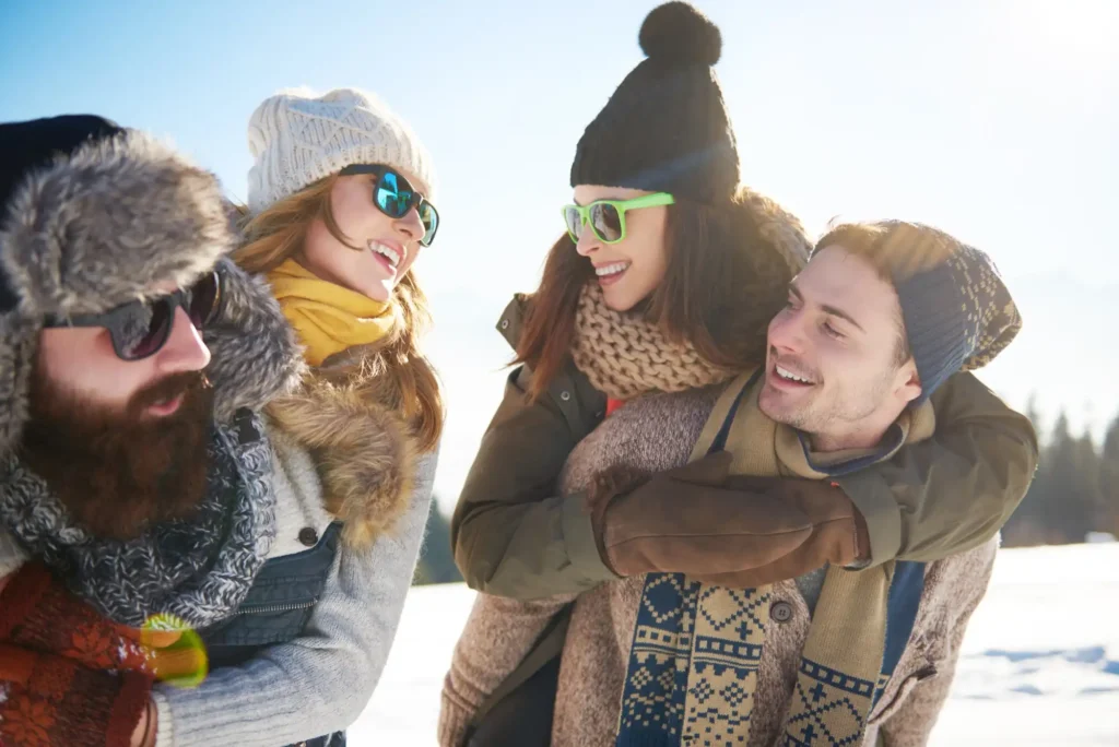 In the image four boys having fun during a winter holiday